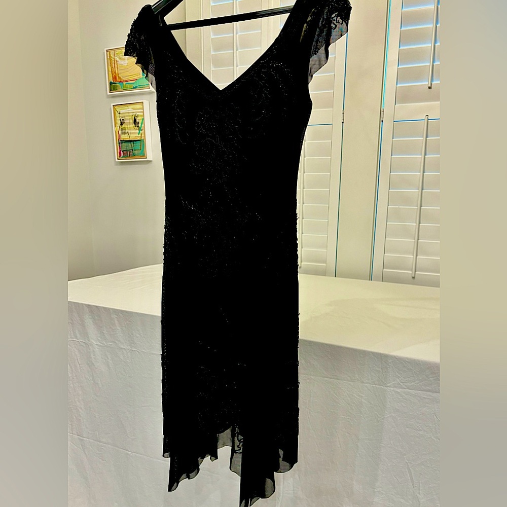 A lovely lightweight handkerchief beaded dress. A flattering fun dress.